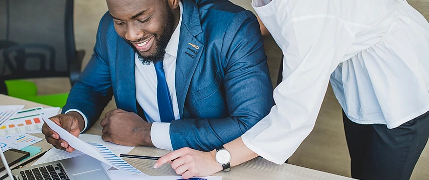 Business professionals reviewing documents for an online BBA application