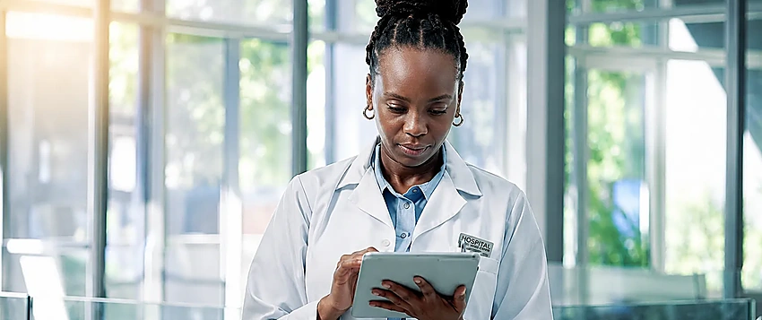 Digital health professional using a tablet in a modern healthcare environment