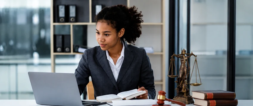 Aspiring family lawyer researching legal documents in a professional office