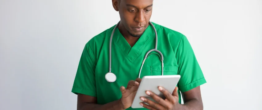 South African healthcare professional using a tablet for NHI readiness planning