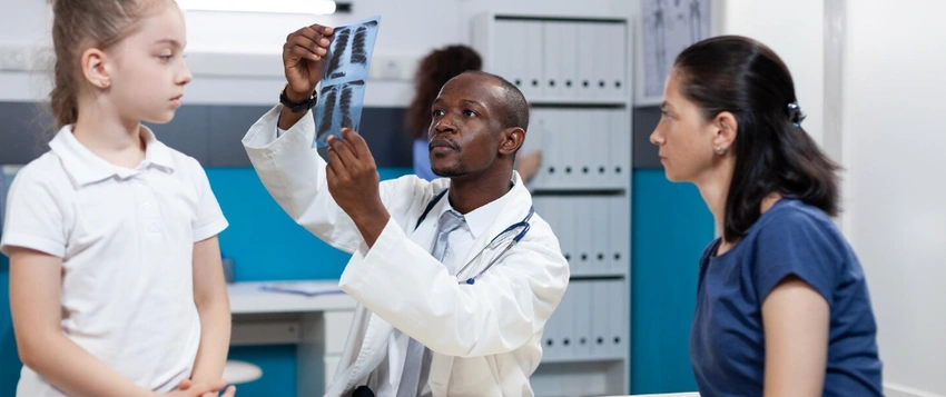 Doctor examining a child during a primary healthcare consultation in South Africa