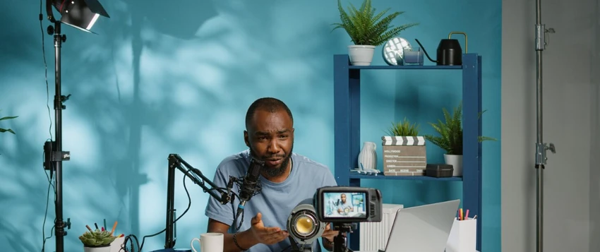 South African content creator recording a professional video with a camera, microphone and laptop
