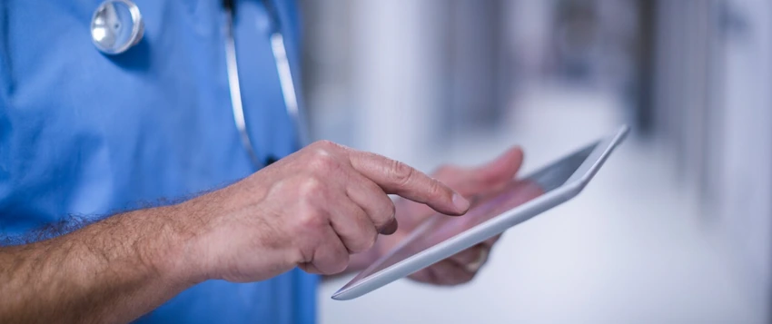Healthcare professional using a tablet for digital health and patient data management