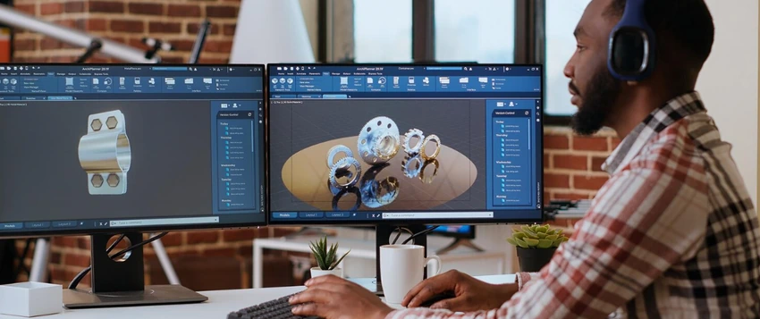 Interactive designer working on 3D digital product designs using dual computer monitors