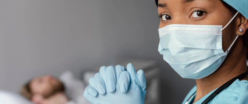 Healthcare professional wearing protective equipment to prevent infection