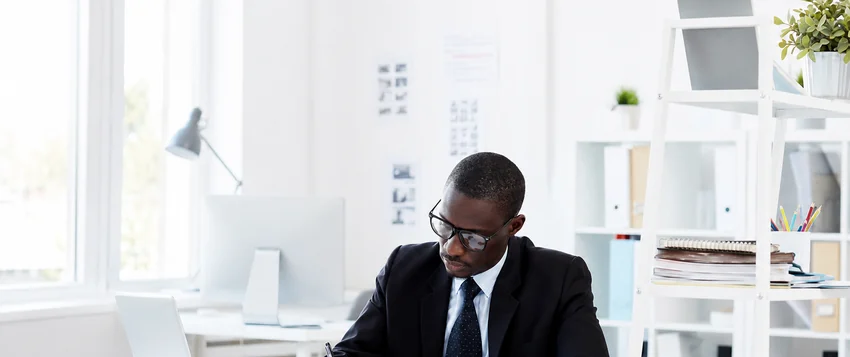 Public management professional reviewing documents in a modern office