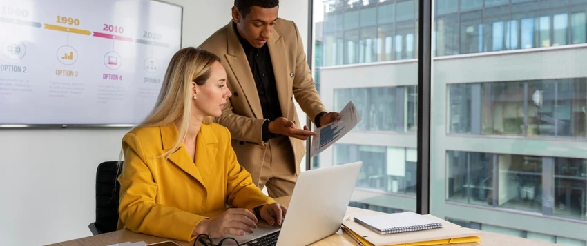 Business professionals reviewing strategic plans and performance data in a modern office