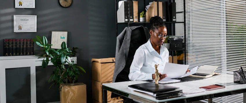 Paralegal professional reviewing legal documents in a modern office