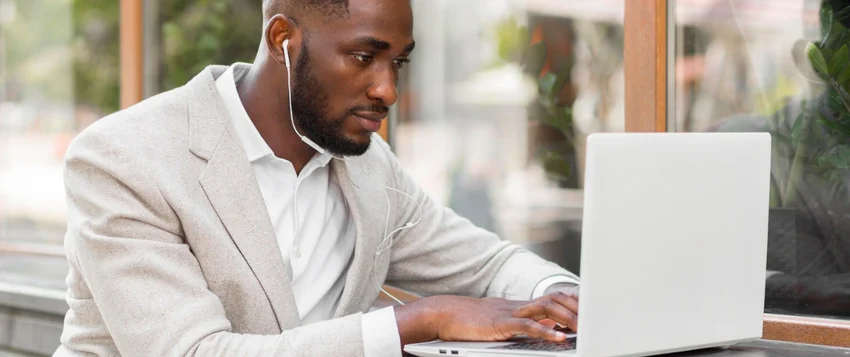 Business professional conducting online doctoral research on a laptop