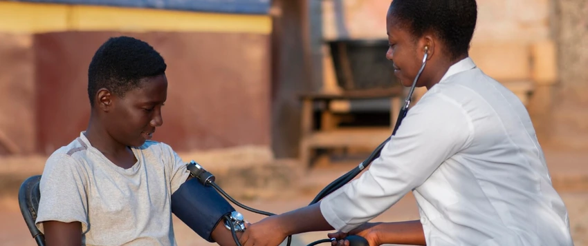 Healthcare professional providing a blood pressure check during community-based primary health care