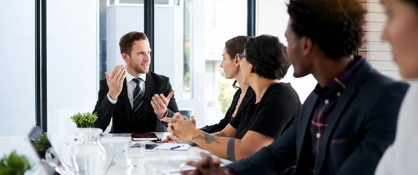 Business leaders discussing management strategy and leadership development in a boardroom