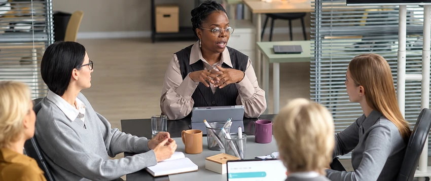 Black business professional leading a strategic management discussion with colleagues