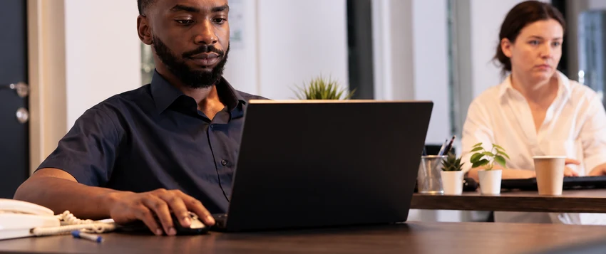Young professional working on a laptop while building practical IT skills in South Africa